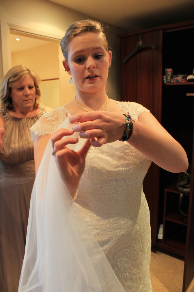 Putting the veil on. 